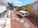 Charming backyard with a picnic table, stone pavers and garden, perfect for outdoor dining and relaxation by the water at 3336 Gulfview Dr, Hernando Beach, FL 34607