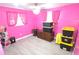 Bedroom featuring pink walls, light gray floors, and ample storage options at 3336 Gulfview Dr, Hernando Beach, FL 34607
