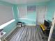 Bonus room with light teal walls, neutral blinds, and gray-toned wood floors at 3336 Gulfview Dr, Hernando Beach, FL 34607