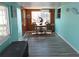 Dining area featuring blue-green walls and a wood paneled accent wall and view to a pool at 3336 Gulfview Dr, Hernando Beach, FL 34607