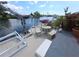 Enjoy outdoor living with a charming patio area on the dock, complete with a mosaic table, seating, and lush landscaping at 3336 Gulfview Dr, Hernando Beach, FL 34607