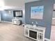Open living area features neutral walls, and a modern entertainment center with an electric fireplace at 3336 Gulfview Dr, Hernando Beach, FL 34607