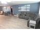 Spacious living room boasts gray sectional sofa, neutral walls, and neutral flooring creating a comfortable atmosphere at 3336 Gulfview Dr, Hernando Beach, FL 34607