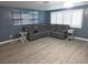 Spacious living room boasts gray sectional sofa, neutral walls, and window shutters, creating a comfortable atmosphere at 3336 Gulfview Dr, Hernando Beach, FL 34607