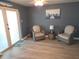 Living room featuring neutral walls, wicker chairs and view to the patio doors at 3336 Gulfview Dr, Hernando Beach, FL 34607