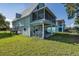 Exterior of home with screened-in porch and covered area, ideal for outdoor relaxation and overlooking the yard at 3363 Poinsettia Dr, Hernando Beach, FL 34607