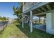 Backyard featuring a covered area under the house and a glimpse of the canal, perfect for outdoor entertaining at 3363 Poinsettia Dr, Hernando Beach, FL 34607