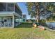 Backyard with lush lawn, access to the canal, and a covered patio, perfect for enjoying waterfront living at 3363 Poinsettia Dr, Hernando Beach, FL 34607