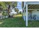 Lush backyard with mature trees, waterfront view, and a covered patio area, ideal for enjoying the outdoors at 3363 Poinsettia Dr, Hernando Beach, FL 34607