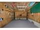 Basement showcasing the plywood walls, concrete flooring, and wooden shelving, perfect for storage or a workshop at 3363 Poinsettia Dr, Hernando Beach, FL 34607