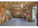 Basement showcasing the plywood walls, concrete flooring, and natural light through the windows, perfect for a workshop at 3363 Poinsettia Dr, Hernando Beach, FL 34607