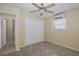 Bright bedroom featuring carpet, ceiling fan, and closet for storage at 3363 Poinsettia Dr, Hernando Beach, FL 34607