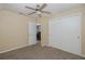 Cozy bedroom features a ceiling fan and a double-door closet for ample storage at 3363 Poinsettia Dr, Hernando Beach, FL 34607
