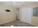 Neutral bedroom features a ceiling fan, closet, and wall-mounted television at 3363 Poinsettia Dr, Hernando Beach, FL 34607