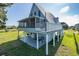 Charming coastal home with screened porch and outdoor entertainment area, perfect for enjoying the outdoors at 3363 Poinsettia Dr, Hernando Beach, FL 34607