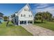 Charming home featuring a unique A-frame design, metal roof, and ample parking underneath on a well manicured lot at 3363 Poinsettia Dr, Hernando Beach, FL 34607