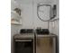 Modern laundry room featuring front-load washer and dryer on a white wall at 3363 Poinsettia Dr, Hernando Beach, FL 34607