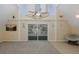 Cozy living room with vaulted ceilings, a ceiling fan, and sliding glass doors to the porch at 3363 Poinsettia Dr, Hernando Beach, FL 34607