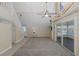 Spacious living room with vaulted ceilings, ceiling fan, and sliding glass doors to the porch at 3363 Poinsettia Dr, Hernando Beach, FL 34607