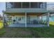 Outdoor patio with charming decor, seating area, grill, and convenient access to outdoor activities at 3363 Poinsettia Dr, Hernando Beach, FL 34607