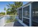 Screened-in porch with white railings, wood floor, and water views at 3363 Poinsettia Dr, Hernando Beach, FL 34607