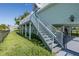 Staircase leading to the home's entrance, offering access to outdoor living spaces with nice lawn at 3363 Poinsettia Dr, Hernando Beach, FL 34607