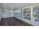 Bright sunroom with water views, wood floors, and ample natural light at 3363 Poinsettia Dr, Hernando Beach, FL 34607