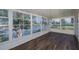 Bright sunroom with water views, wood floors, and ample natural light at 3363 Poinsettia Dr, Hernando Beach, FL 34607