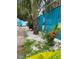 A backyard with lush landscaping of plants and rocks next to a blue fence at 3530 Beechwood N Ter, Pinellas Park, FL 33781