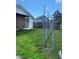 A view of the chain link fence in the backyard with manicured lawn and side of house at 3530 Beechwood N Ter, Pinellas Park, FL 33781