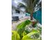 Backyard featuring lush landscaping of plants, rocks, pavers, and white siding on house at 3530 Beechwood N Ter, Pinellas Park, FL 33781