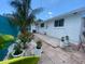 Backyard featuring potted plants, landscaping, stone, and pavers with white siding on house at 3530 Beechwood N Ter, Pinellas Park, FL 33781