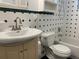 A bathroom with a vanity sink, toilet, and tub, showcasing the vintage-style tile and built-in cabinets at 3530 Beechwood N Ter, Pinellas Park, FL 33781