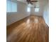 Spacious bedroom with hardwood floors, windows providing natural light, and ceiling fans for added comfort at 3530 Beechwood N Ter, Pinellas Park, FL 33781