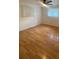 Bedroom with ceiling fan, hardwood flooring, and two large windows at 3530 Beechwood N Ter, Pinellas Park, FL 33781