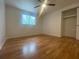 Well-lit bedroom with hardwood floors, a ceiling fan, and a closet at 3530 Beechwood N Ter, Pinellas Park, FL 33781