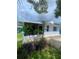 A view of the home's exterior showing the sunroom, plants, siding and a well-manicured lawn at 3530 Beechwood N Ter, Pinellas Park, FL 33781