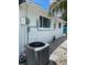 Side of a home with an AC unit, utility boxes, and windows, all freshly painted white at 3530 Beechwood N Ter, Pinellas Park, FL 33781