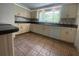 Well-lit kitchen featuring neutral cabinetry, stainless steel appliances, and ceramic tile flooring at 3530 Beechwood N Ter, Pinellas Park, FL 33781
