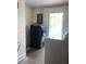 A well-lit laundry area equipped with a modern, stacked washer and dryer set for efficient space-saving at 3530 Beechwood N Ter, Pinellas Park, FL 33781