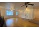 Spacious living room with hardwood floors and ample natural light from large windows at 3530 Beechwood N Ter, Pinellas Park, FL 33781