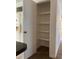 Pantry featuring open shelving adjacent to kitchen, offering ample storage space for groceries and supplies at 3530 Beechwood N Ter, Pinellas Park, FL 33781