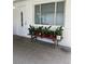 Comfortable outdoor space showing a bench with potted plants adjacent to a door and window at 3530 Beechwood N Ter, Pinellas Park, FL 33781
