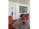 Charming covered patio setup featuring a glass top table, four ornate chairs, and potted plants at 3530 Beechwood N Ter, Pinellas Park, FL 33781