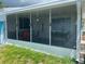 A view of the sunroom featuring neutral walls, windows, seating and a light-colored door at 3530 Beechwood N Ter, Pinellas Park, FL 33781
