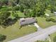 Aerial view of a home surrounded by a large lot, mature trees, and a long driveway at 37722 Granada Ave, Dade City, FL 33525