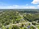 Wide aerial perspective highlighting the community's layout amidst lush greenery and residential homes at 37722 Granada Ave, Dade City, FL 33525