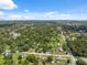 Aerial view captures the serene neighborhood with tree-lined streets and residential properties from above at 37722 Granada Ave, Dade City, FL 33525
