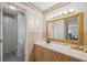 Tasteful bathroom with a large vanity, framed mirror, and walk-in shower at 37722 Granada Ave, Dade City, FL 33525