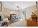 Cozy bedroom with plush carpet, ceiling fan and two side tables with lamps at 37722 Granada Ave, Dade City, FL 33525